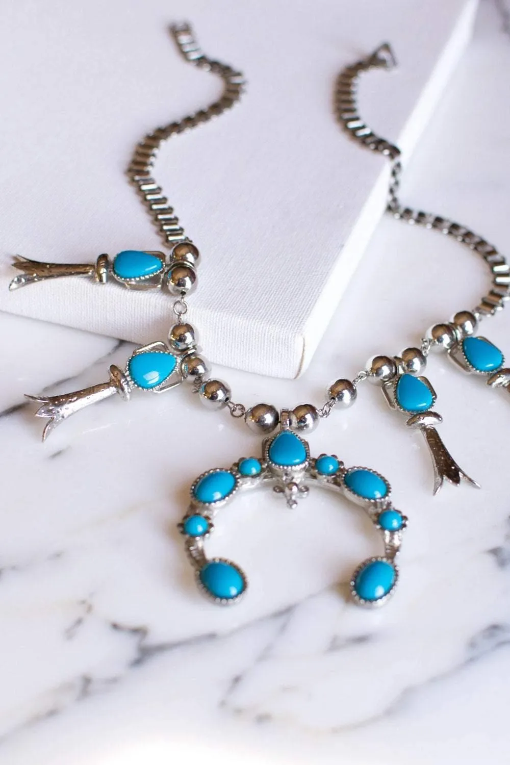 Silver tone necklace with pendant and turquoise
